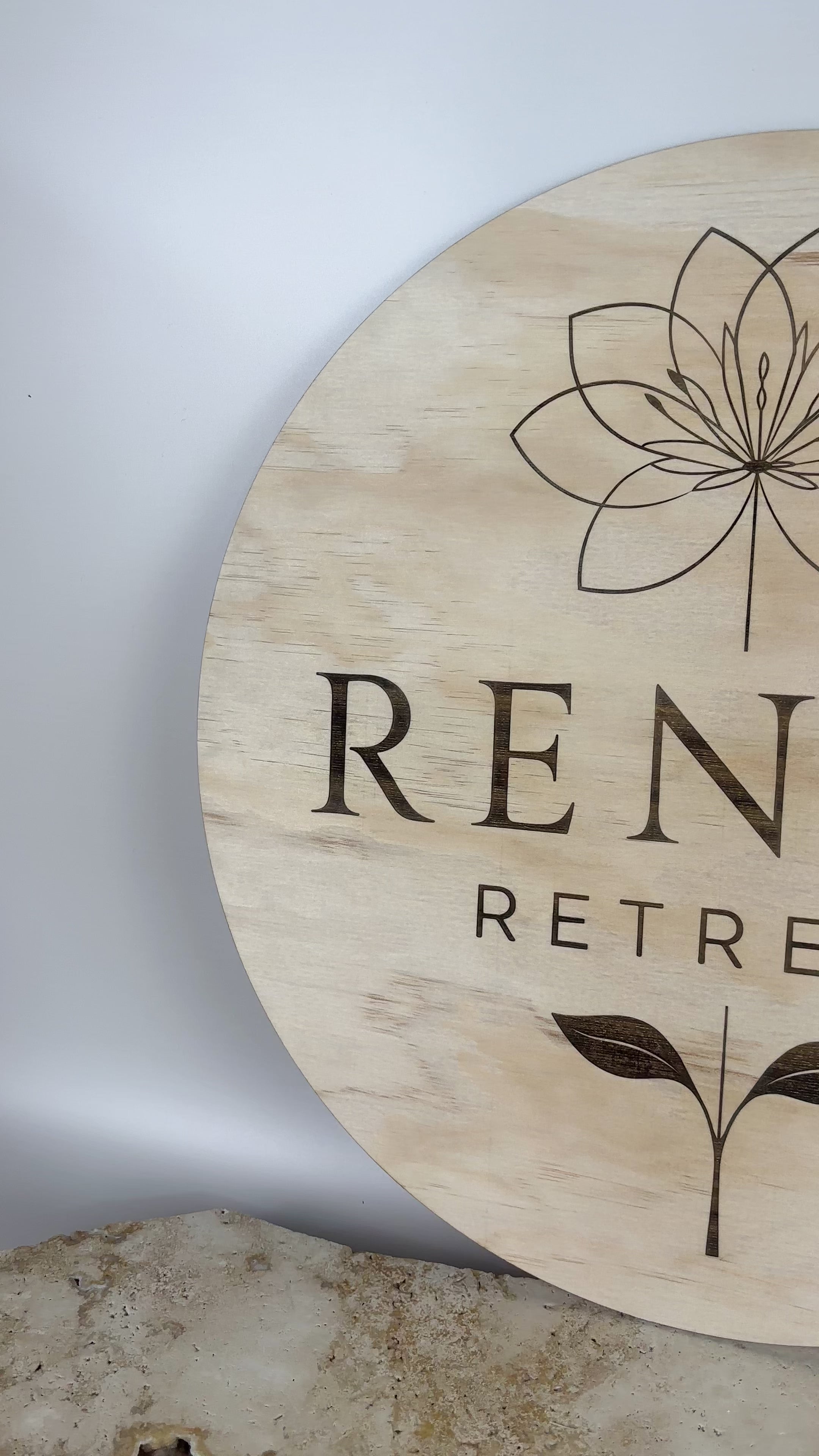 Custom engraved timber business sign for Renue Retreat featuring lotus and leaf design