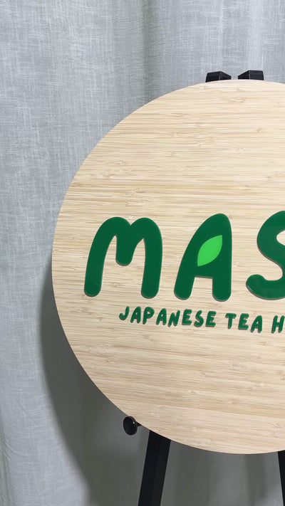 Video showcasing custom round bamboo business sign for Masu Japanese Tea House featuring 3D green acrylic logo and leaf detail – modern eco-friendly signage handmade in Australia by Laser Edge Designs.