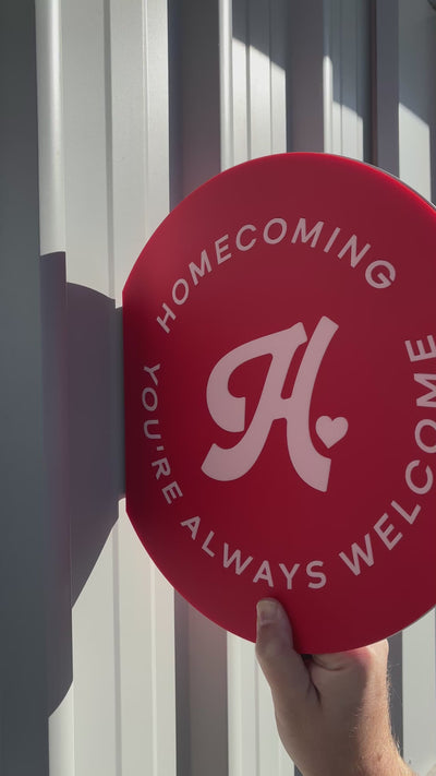 Custom red circular business sign with white logo and text