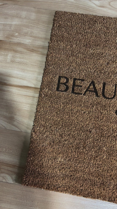 Close up of personalised beauty studio logo on a door mat. Video 