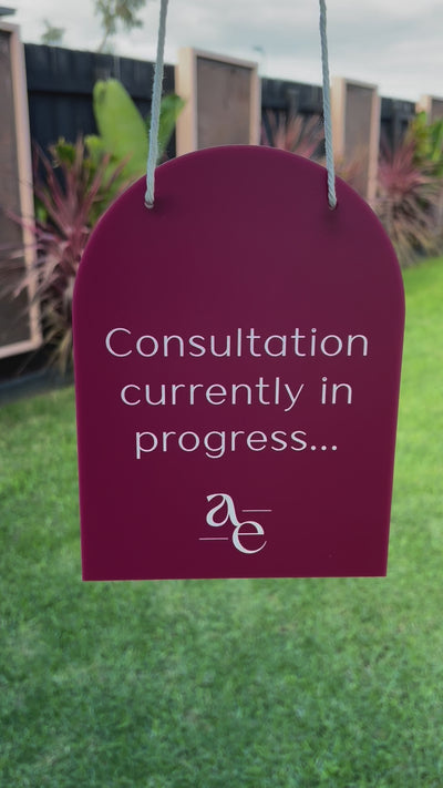 Purple mini arched hanging sign with custom message “Consultation currently in progress…” displayed outdoors. Video 