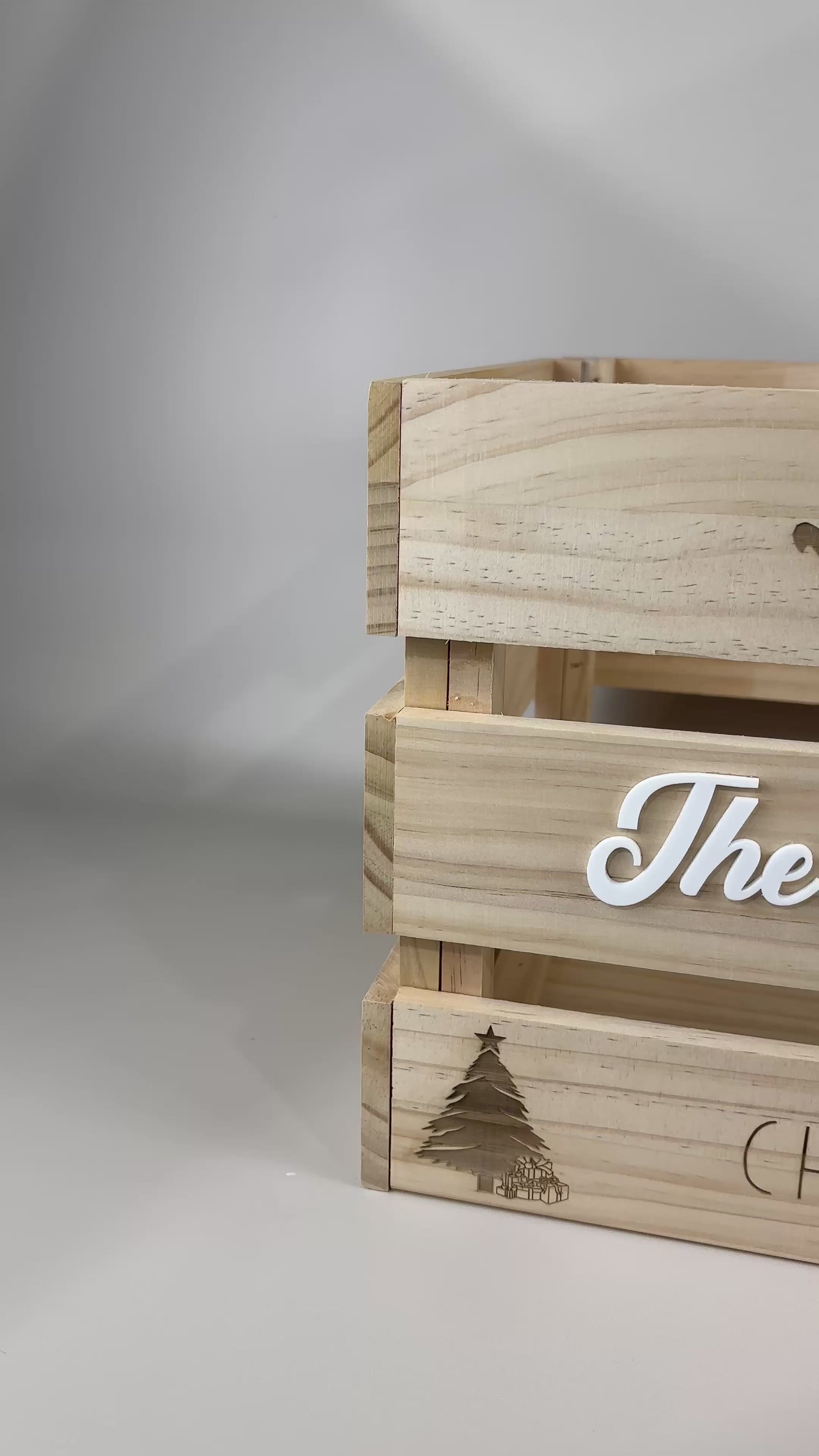 Close-up video of a custom wooden Christmas Eve box with engraved Santa sleigh and reindeer design, white acrylic family name “The Harvey Family,” and engraved “Christmas Eve Box” text — ideal for showcasing family Christmas gift boxes.