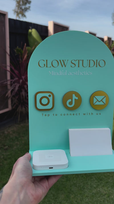 Personalised NFC business station in teal with square dock and card holder – Glow Studio logo with social media icons. Video 