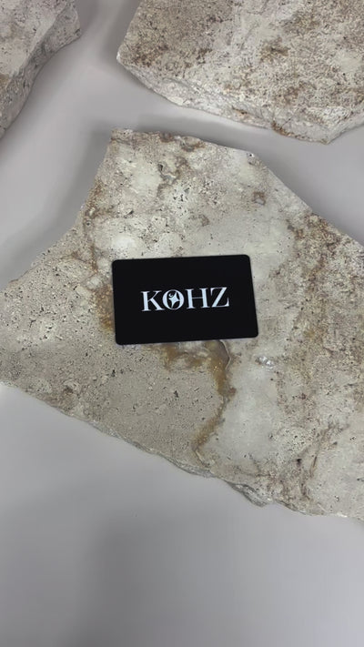 Black matte NFC smart card with custom business branding on textured surface video 