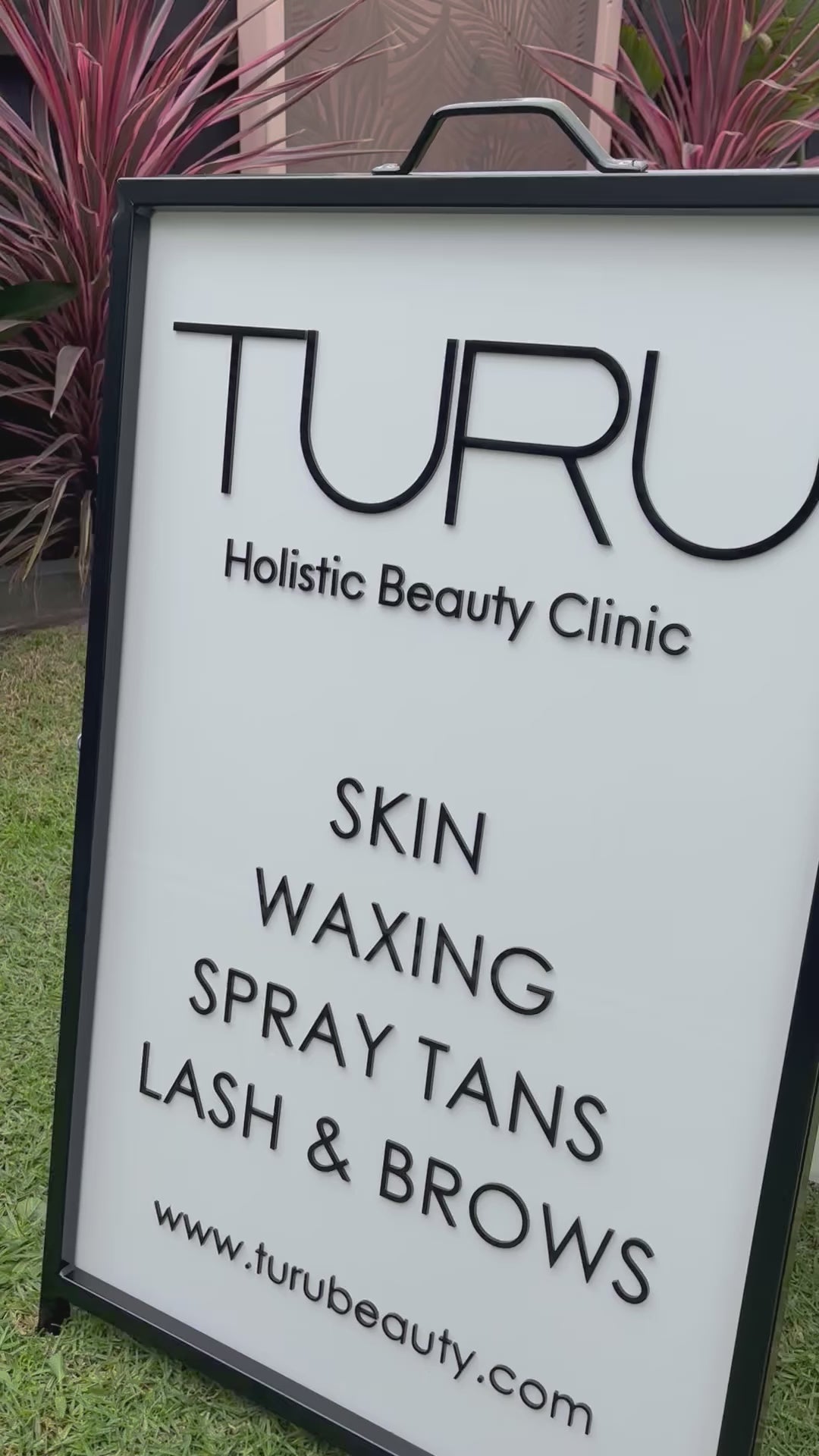 Close up of custom portrait A frame clinic sign for skin waxing and spray tans. Video 