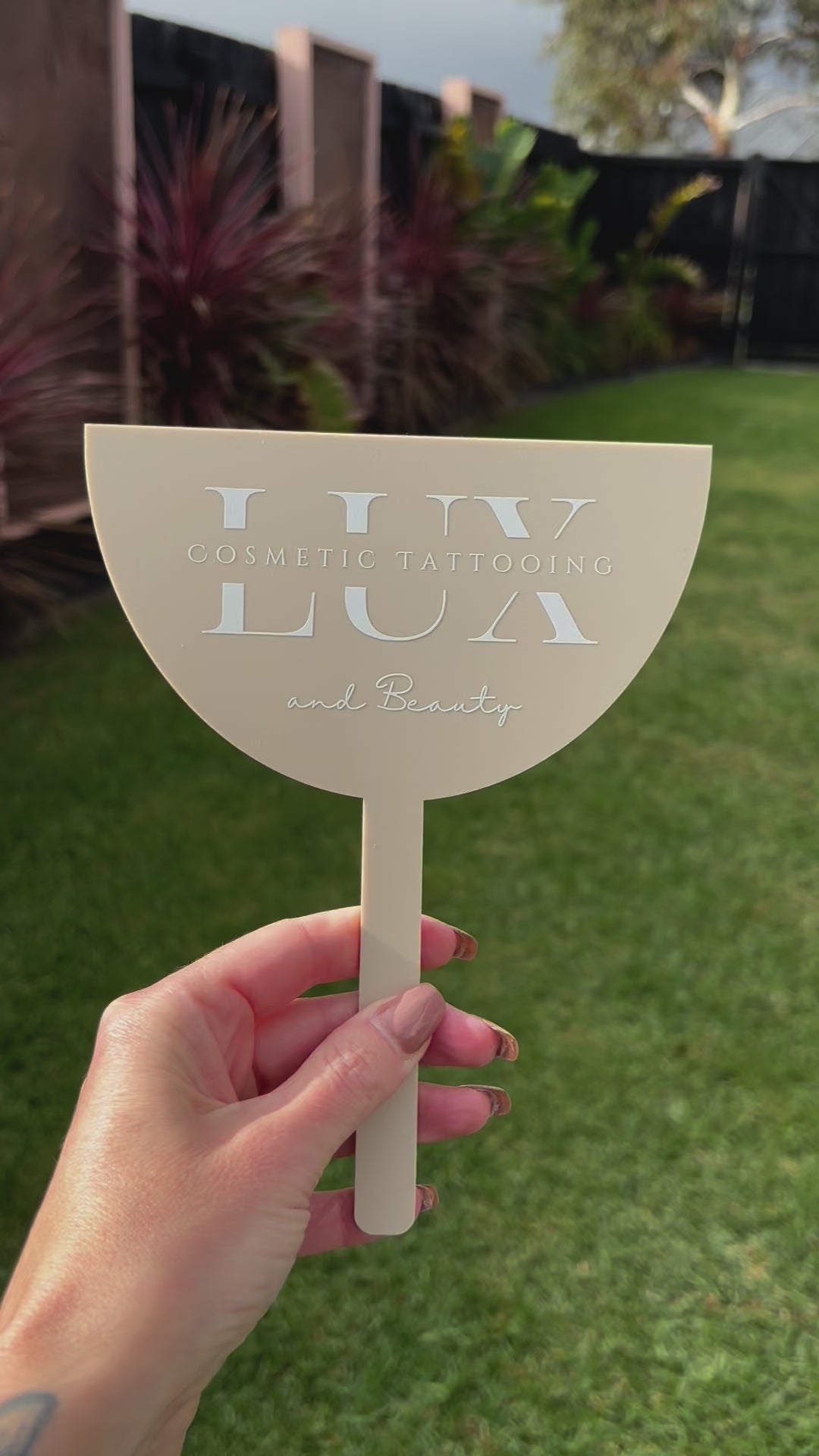 Video beige branded face shield with custom business logo displayed outdoors