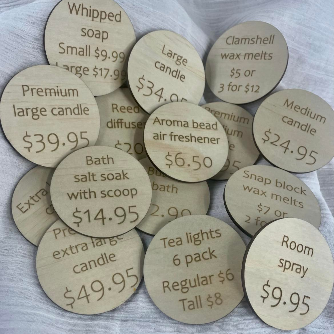 Timber price discs engraved with product details and dollar values