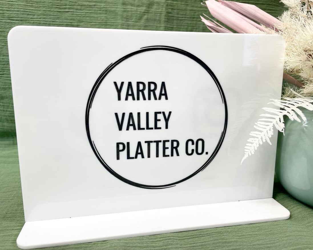 Close-up of Yarra Valley Platter Co logo on white acrylic double sided stand – personalised business sign for catering and platter services