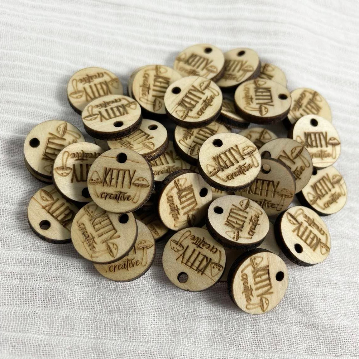 Set of small round engraved wooden tags for handmade gifts