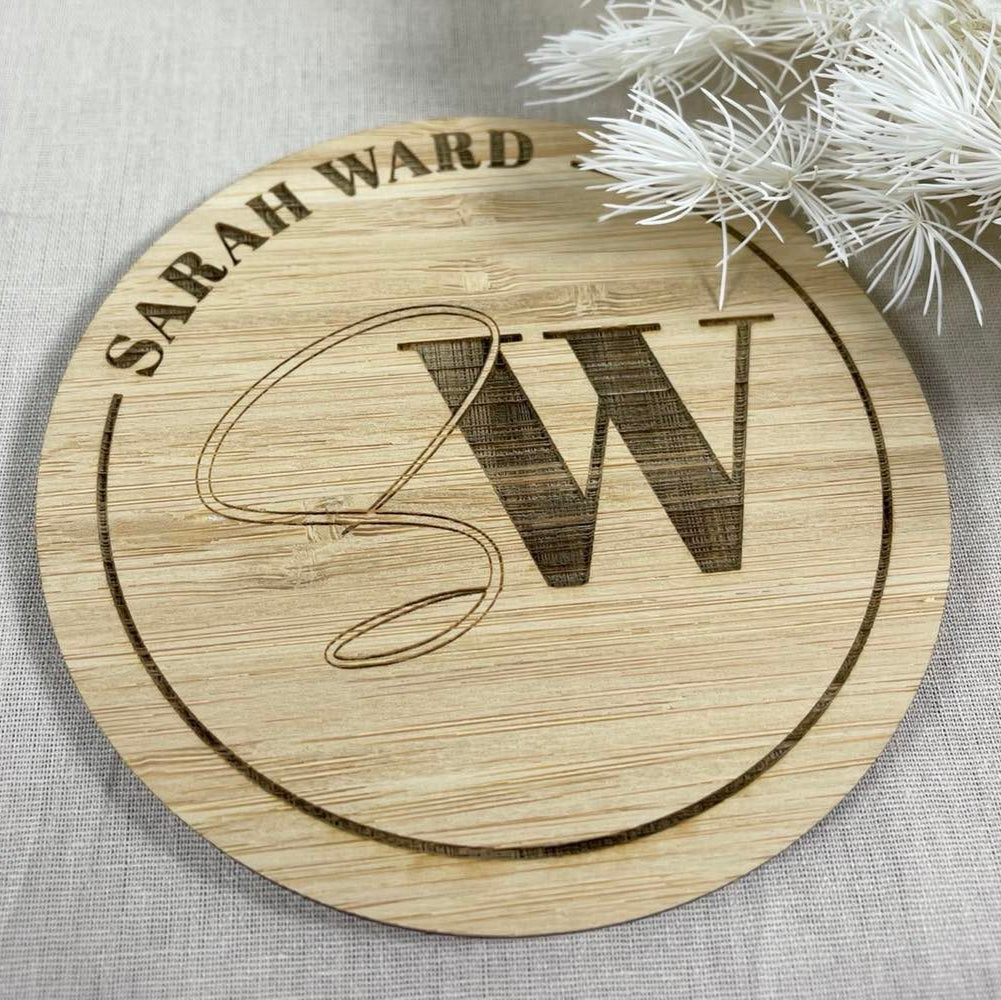 Personalised bamboo logo disc with engraved initial and business name – photo branding accessory