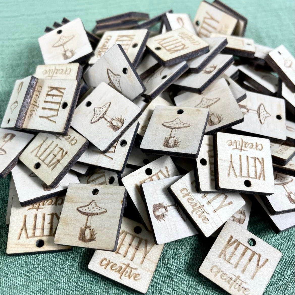 Mixed collection of square timber tags engraved with shop names