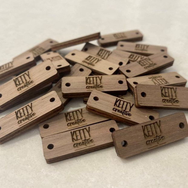 Stack of personalised rectangle tags laser engraved with business logos