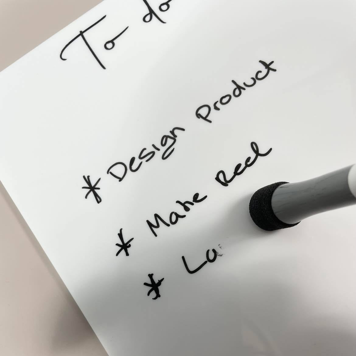 Close up of branded acrylic task board with marker