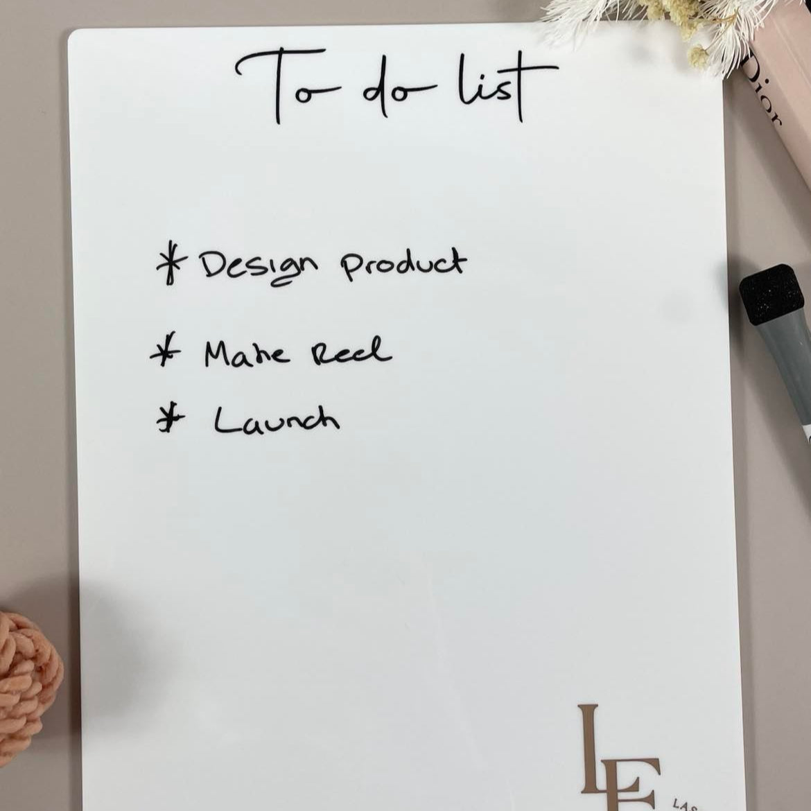 Reusable acrylic to do list showing handwritten tasks
