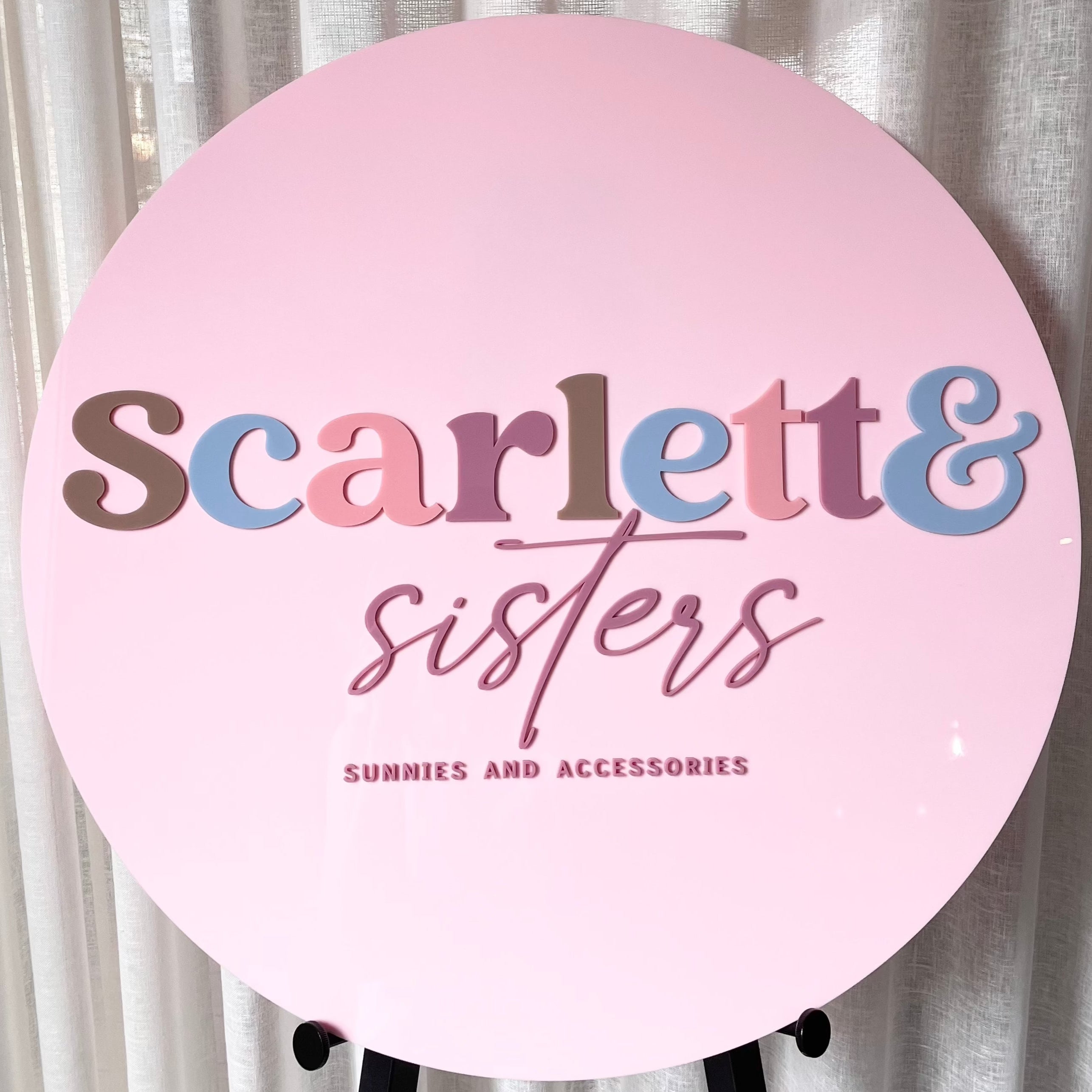 soft pink round business sign with scarlett & sisters text