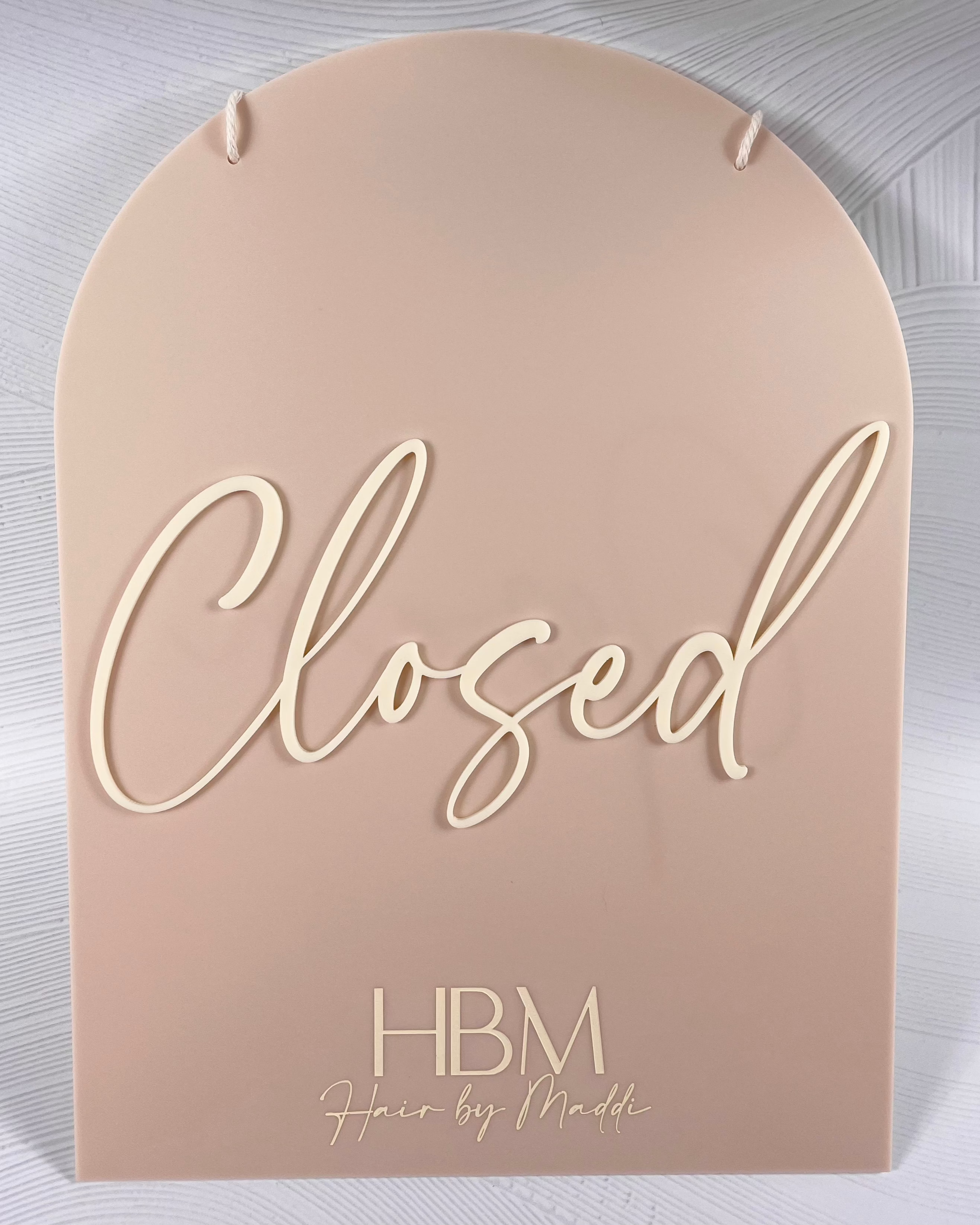 Closed sign in matching soft beige acrylic with white script – business sign