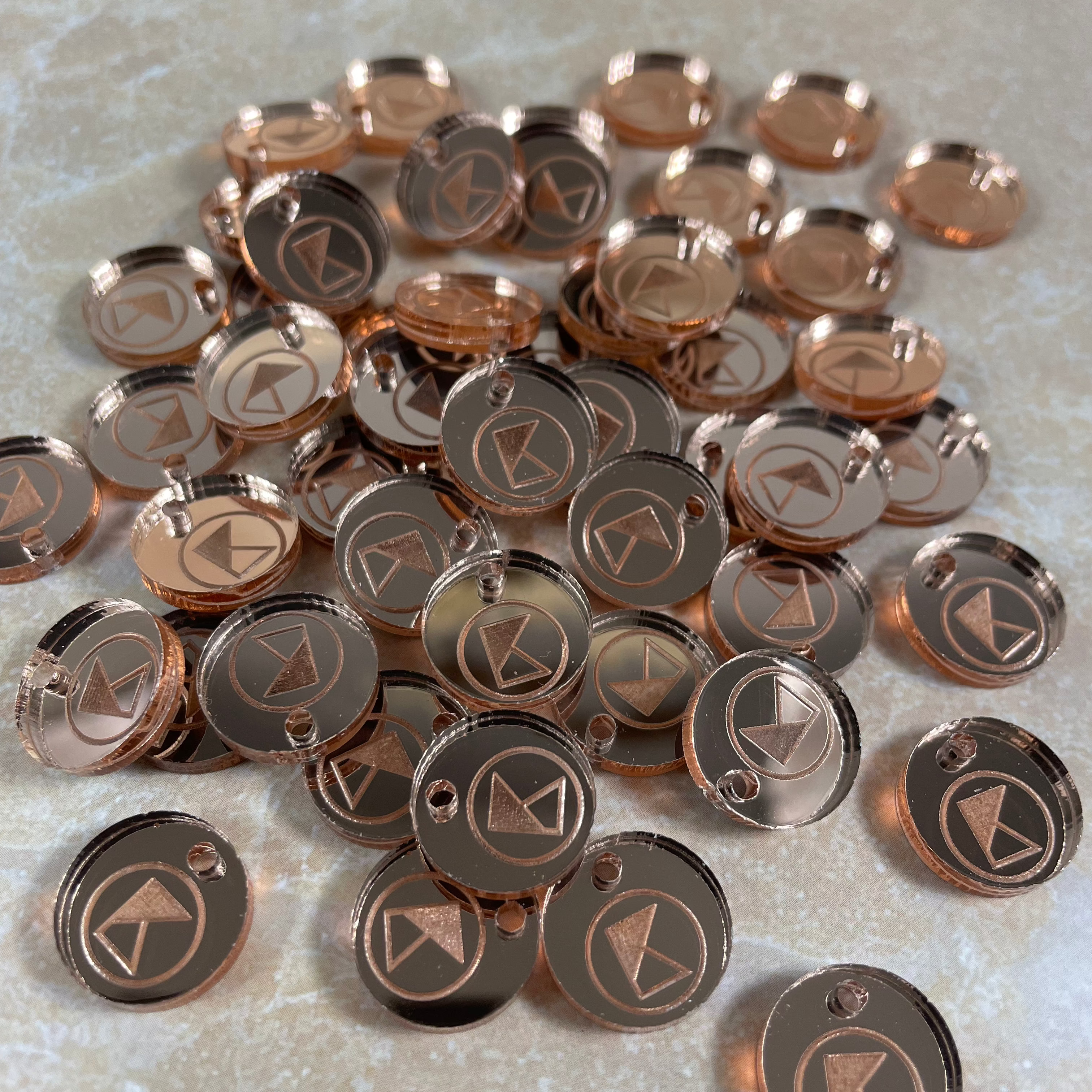 Bulk order of round brown acrylic product tags with custom business logo
